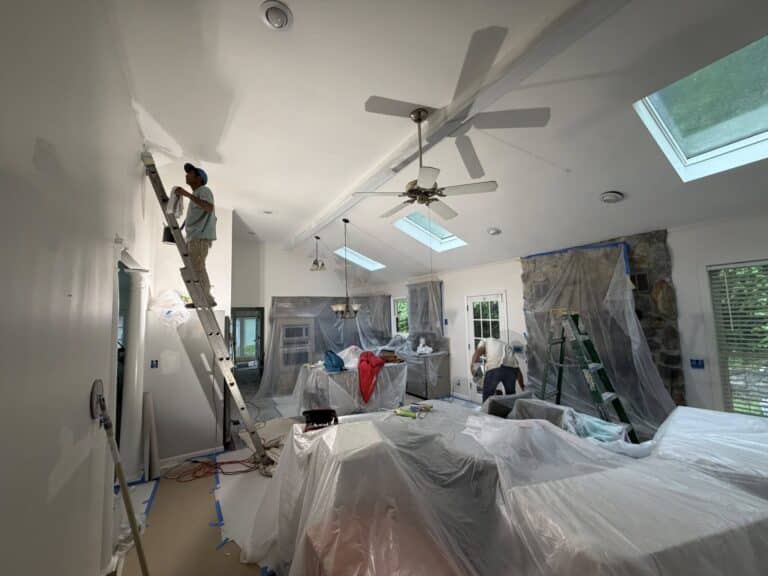 Bison Works painter on ladder preparing walls for paint and finish in Middle Tennessee home